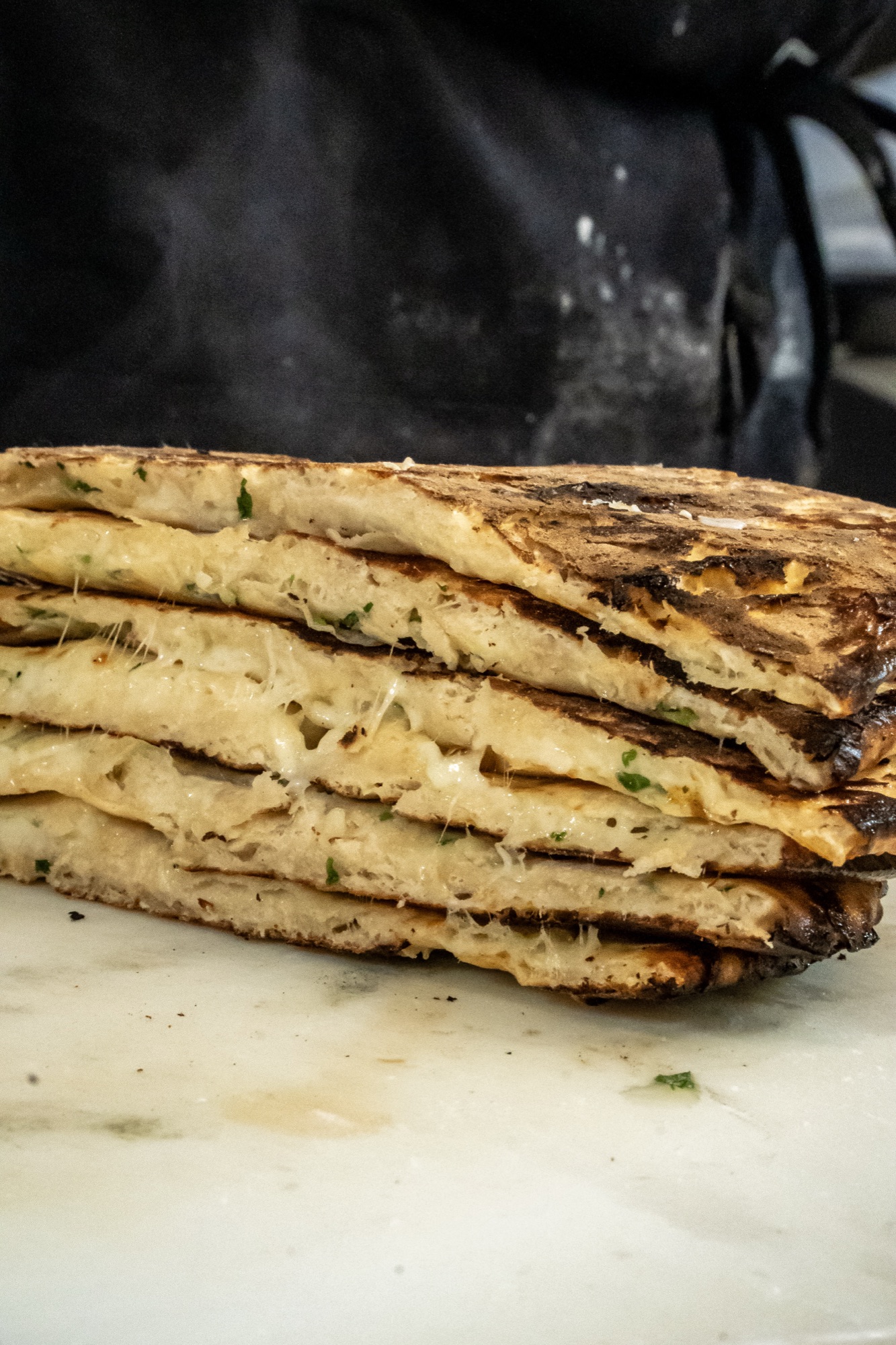 Stacked cheese naan with molten cheese pull